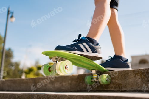 Preview: Close up of skateboarder feet while skating in the park