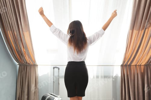 Preview: Woman enjoys morning light in hotel room during a business trip