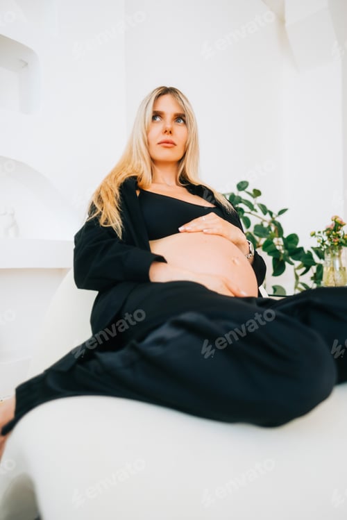 Preview: Portrait of attractive woman enjoying pregnancy, smile, relaxing, hugging belly