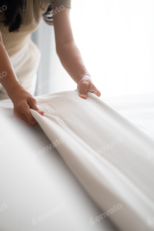 Preview: Housewife set up white sheet and cleaning in room. Housewife