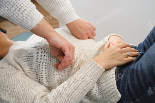 Preview: osteopath working with female patient shoulder