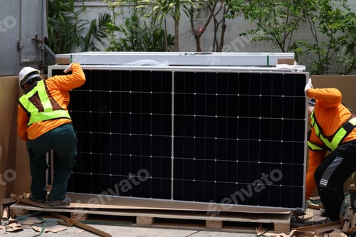Preview: Technicians Install photovoltaic solar modules on roof of house.