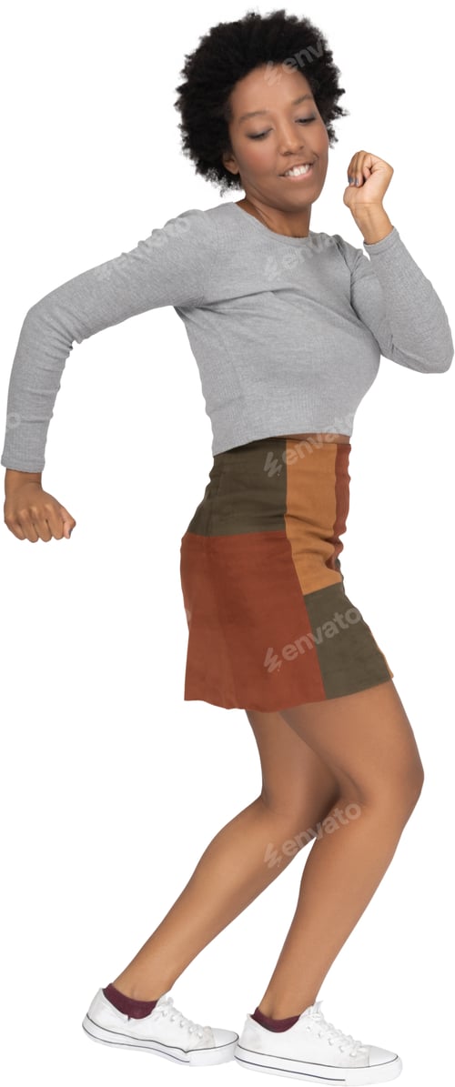 Preview: a woman wearing a skirt and a gray shirt and white shoes