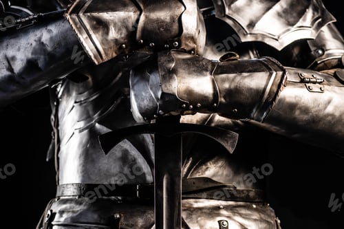 Preview: cropped view of knight in armor holding sword isolated on black