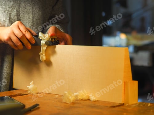 Preview: woman maker artisan working with plane on wooden background
