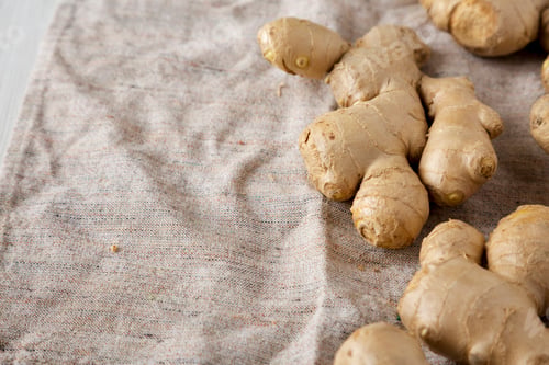 Preview: Raw Organic Ginger Root on cloth, low angle view. Copy space.