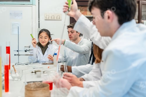 Preview: Chemistry students collaborating on experiment in university lab