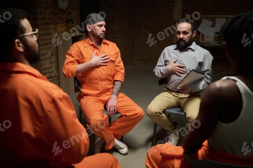 Preview: Diverse Group of Incarcerated Men Participating in Therapy Session in Prison