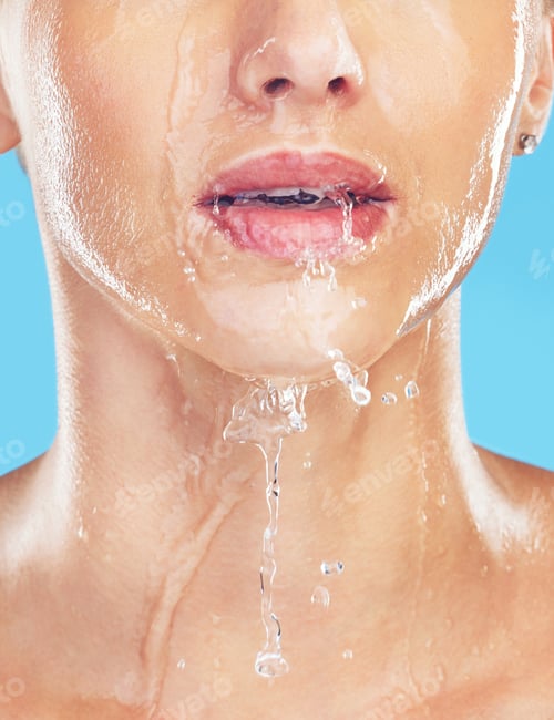 Preview: Woman in shower, water splash on mouth and skincare beauty in morning with blue background. Healthy