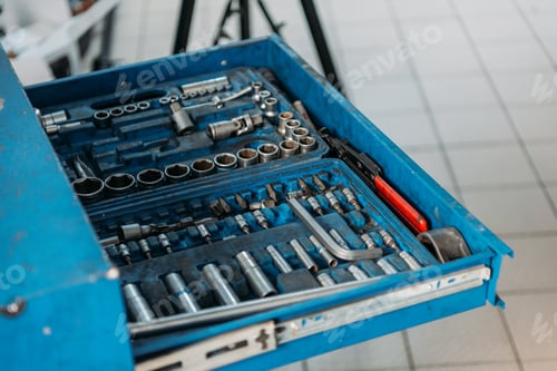 Preview: An open shelf filled with car repair tools in a service workshop.