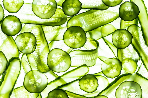 Preview: Fresh Green Cucumber Slices. White Background. Food Abstract Pattern