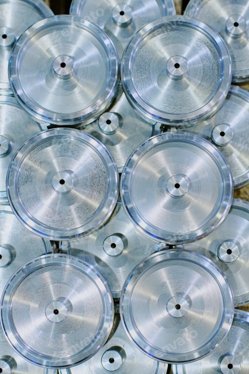 Preview: Stacked Metal Discs Arranged in Patterned Formation Reflecting Light