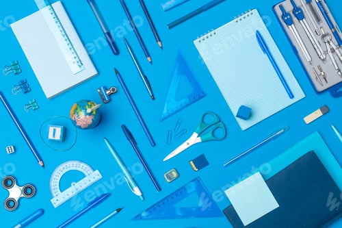Preview: school supplies at colorful paper background