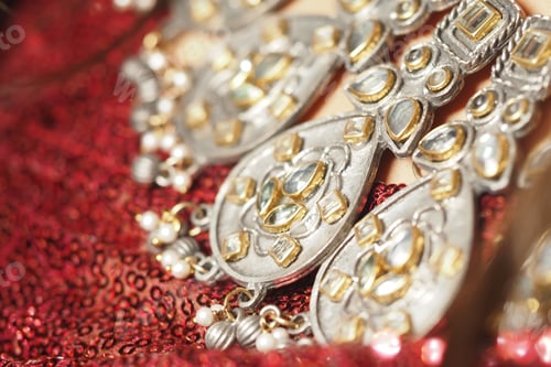 Preview: Ornate jewelry displayed on rich fabric during a cultural celebration
