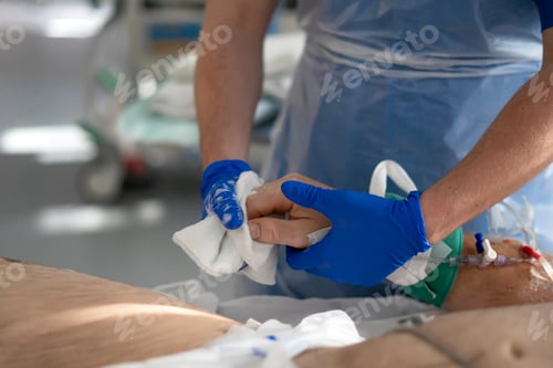 Preview: Nurse cleaning patient's hand in hospital room with iv drip