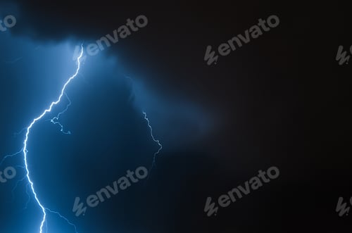 Preview: Lightning in the night sky. Thunderstorm over the city. Stormy clouds and rainy weather.