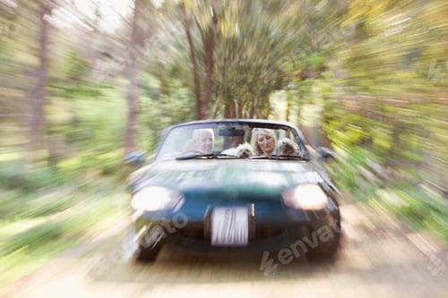 Preview: Blurred view of convertible on dirt path