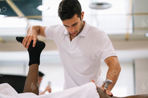 Preview: Man providing physical therapy to another adult