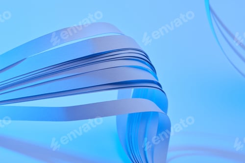 Preview: close up view of curved colorful paper stripes on neon blue background