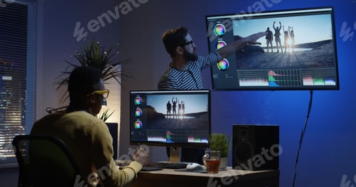 Preview: Medium Shot Of A Young Man Sitting Back And Editing A Video Inside A Modern Video Studio