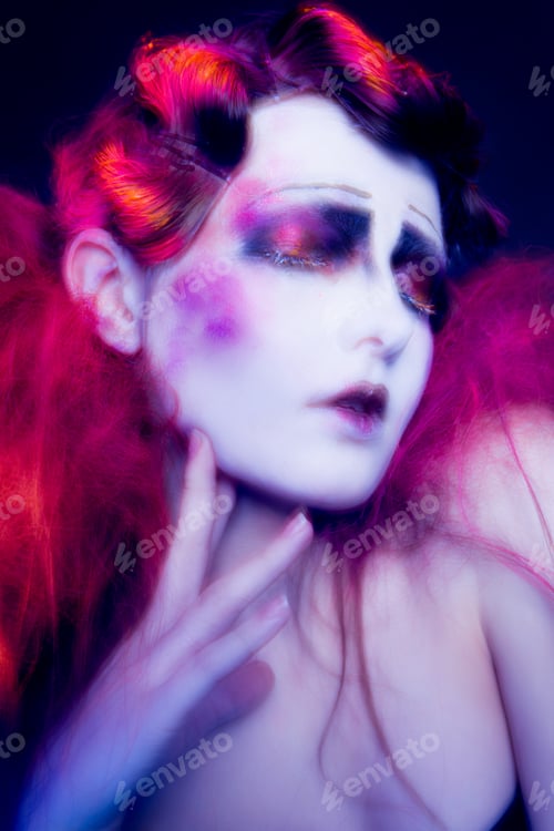 Preview: High Fashion model woman in colorful bright lights posing in studio