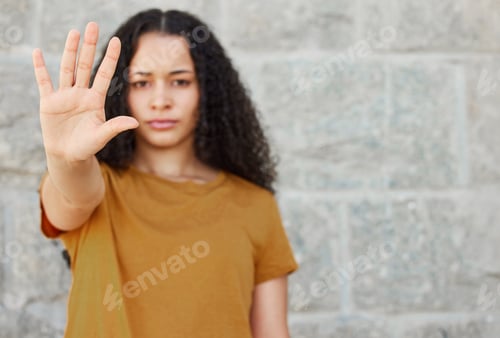 Preview: Lets put a stop to it. Shot of a young woman showing the stop gesture while standing outside.