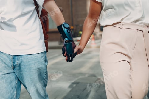 Preview: Young disabled man with artificial prosthetic hand walking and holding woman girlfriend hand.