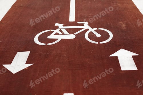 Preview: New marking bike path. White bicycle symbol and two oposite arrows on red asphalt lane, road. Bicycl