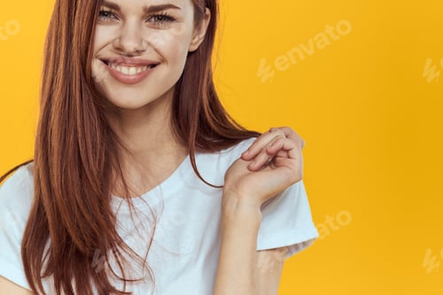 Preview: Beautiful woman in white t-shirt long hair glamor close-up yellow background