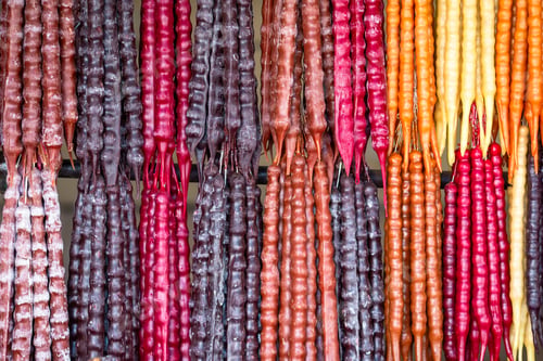 Preview: Multicolored delicious fresh Georgian Sweets Churchkhela hanging in the market