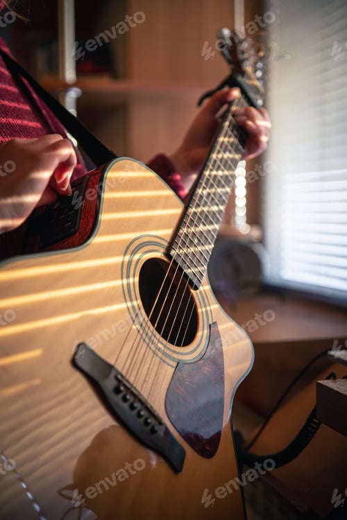 Preview: Girl with a guitar in the sunlight through the blinds.