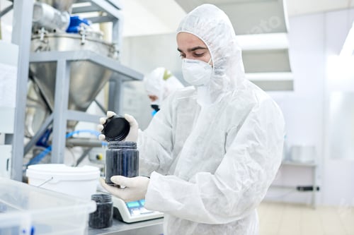 Preview: Factory worker closing plastic container with product