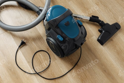 Preview: Vacuum cleaner on the wooden floor in living room. Heart Shape. Clean House Concept. Close-up