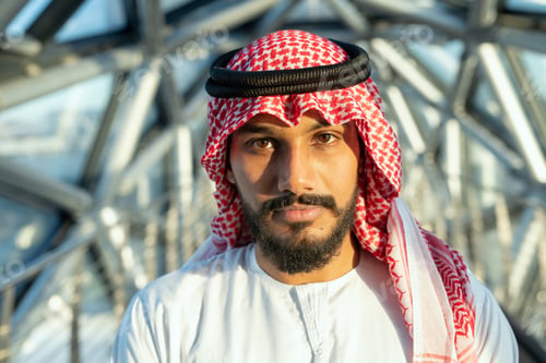 Preview: Serious young Arab male delegate or businessman in national white attire