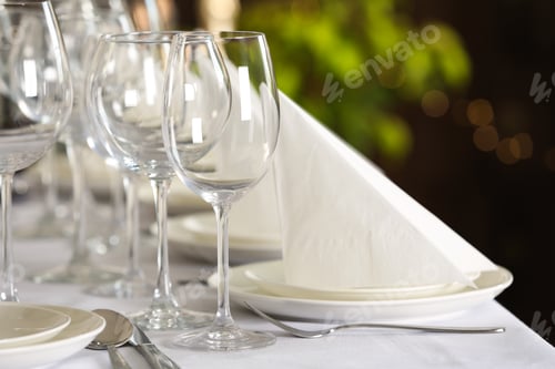 Preview: Table setting with empty glasses, plates and cutlery indoors