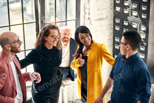 Preview: Beautiful business people are using gadgets, talking and smiling during the conference in office