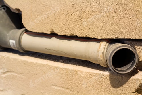 Preview: Installation of sewer pipes in a bathroom of an apartment interior during renovation works. Gray