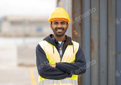 Preview: indian engineer man working in logistics at container port - migrant worker man concept -