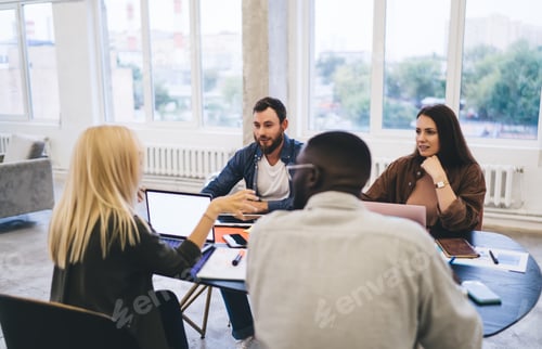 Preview: Group of diverse colleagues on meeting in workspace