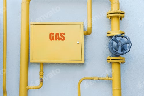 Preview: Gas meter box and pipes near grey wall outdoors