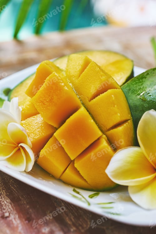 Preview: Fresh mango on a wooden tabel with tropical background. Soft focus.