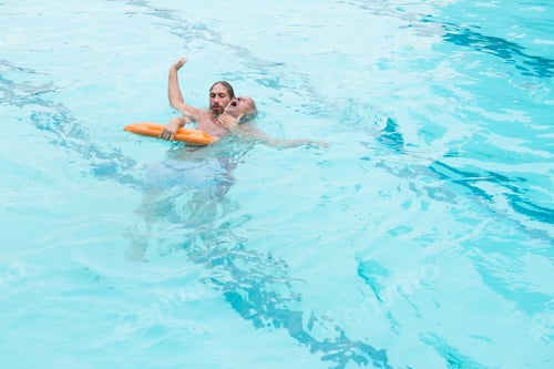 Preview: Lifeguard rescuing senior man from swimming pool