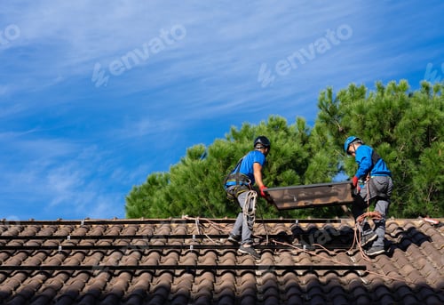 Preview: Two men installing solar panels