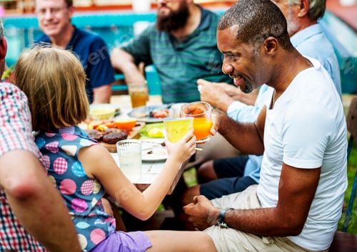 Preview: Black man clinking drink with young girl in summer party