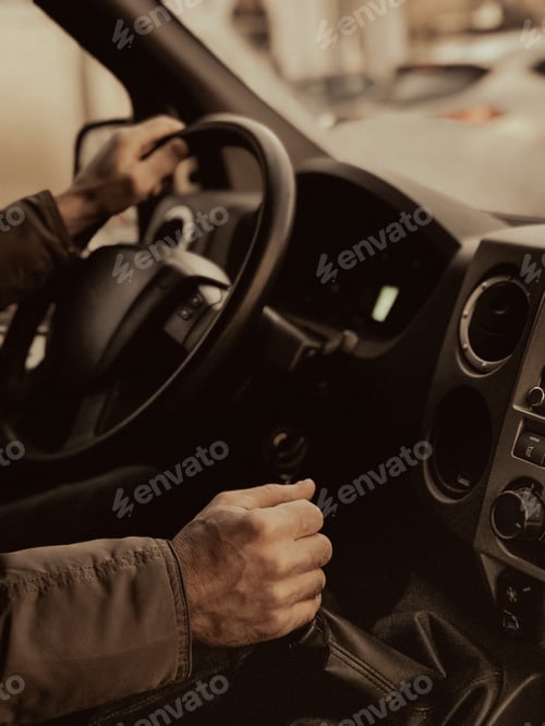 Preview: A man is driving a truck. Close-up. A man's hand switches the gear lever