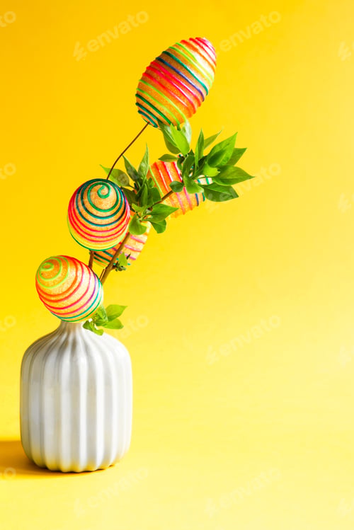 Preview: A bouquet of green branches with blooming fresh leaves in a vase is decorated with colorful rainbow