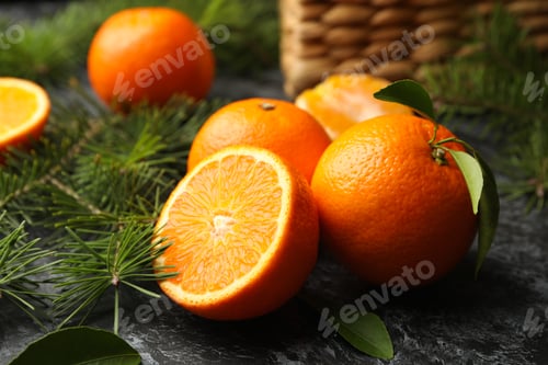 Preview: Mandarins, pine branches and basket on gray smoky background