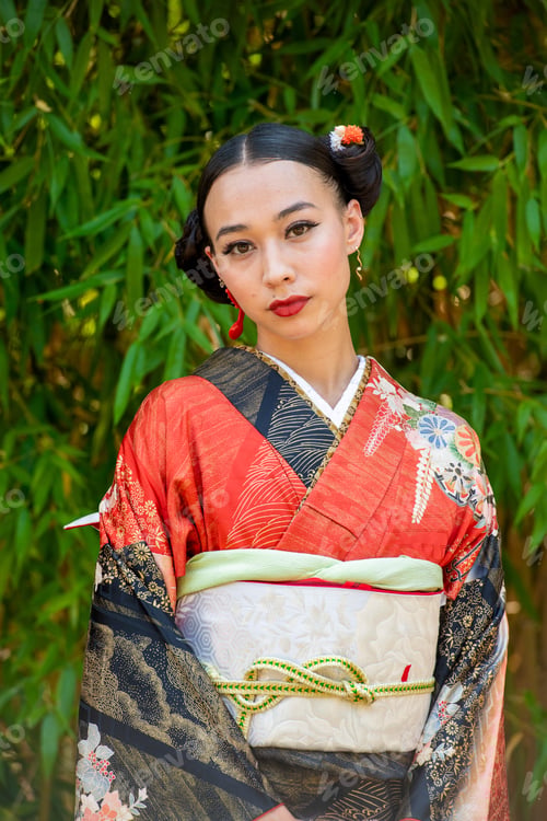 Preview: Elegant woman in traditional Japanese kimono standing before bamboo