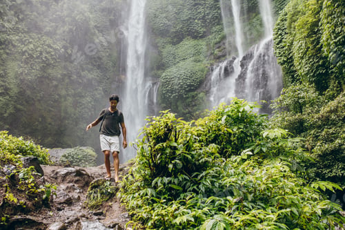 Preview: Young man walking along mountain trail