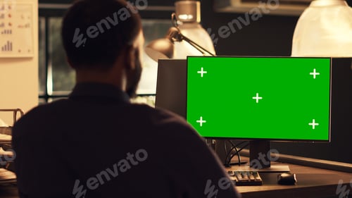 Preview: Successful office worker analyzing computer monitor with greenscreen